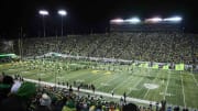 Nov 24, 2023; Eugene, Oregon, USA; Oregon Ducks fans cheer as the Ducks football team take the field before a game against the Oregon State Beavers at Autzen Stadium. Mandatory Credit: Troy Wayrynen-USA TODAY Sports