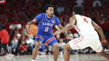 Mar 3, 2025; Houston, Texas, USA; Houston Cougars guard L.J. Cryer (4) defends against Kansas Jayhawks guard David Coit (8) during the first half at Fertitta Center. Mandatory Credit: Troy Taormina-Imagn Images