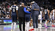Irving is helped off the court after suffering an ACL injury on Monday.