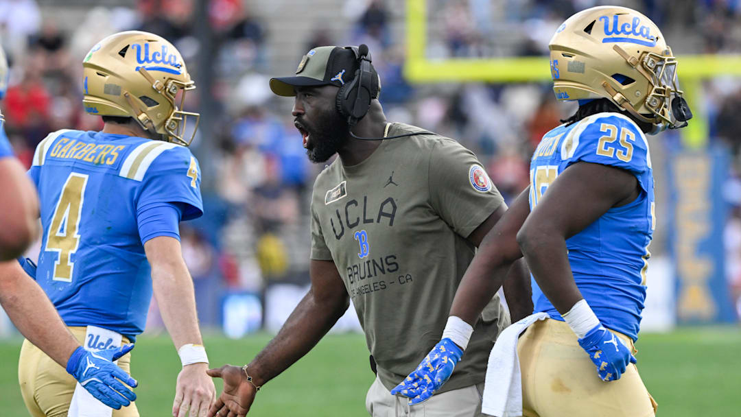 Nov 30, 2024; Pasadena, California, USA; UCLA Bruins head coach DeShaun Foster greets quarterback Ethan Garbers (4) during the third quarter against the Fresno State Bulldogs at Rose Bowl. Mandatory Credit: Robert Hanashiro-Imagn Images