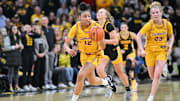 Feb 2, 2025; Iowa City, Iowa, USA; USC Trojans guard JuJu Watkins (12) drives the ball late during the second quarter against the Iowa Hawkeyes as guard Avery Howell (23) looks on at Carver-Hawkeye Arena. Mandatory Credit: Jeffrey Becker-Imagn Images