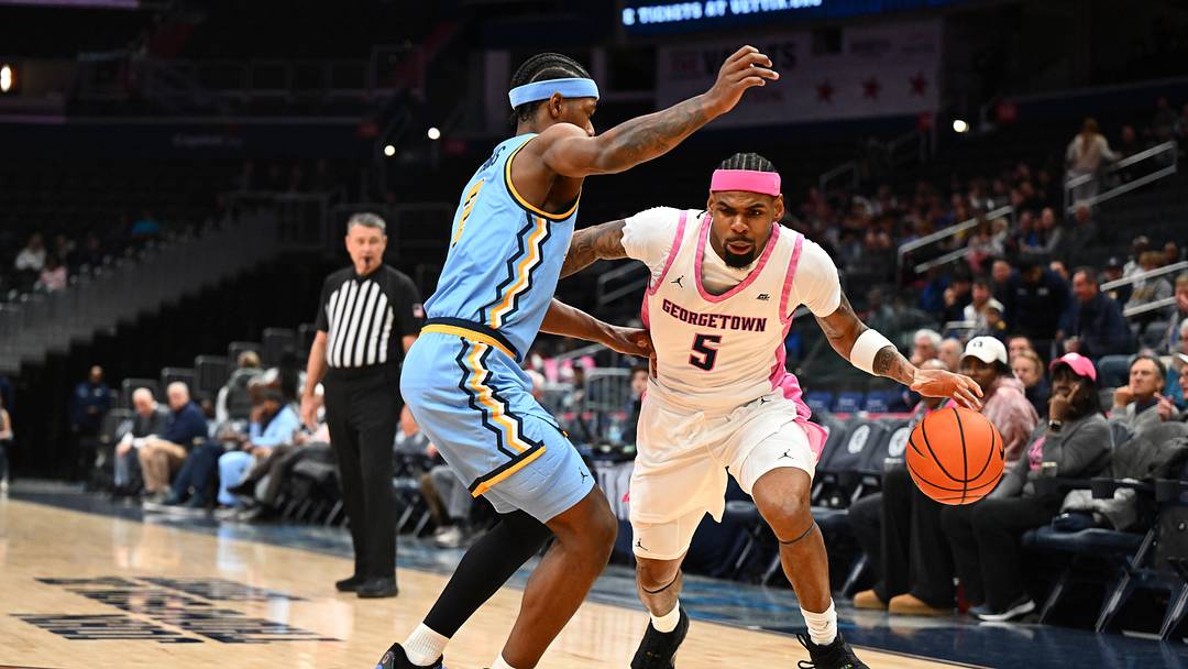 Feb 24, 2026; Washington, District of Columbia, USA; Georgetown Hoyas guard KJ Lewis (5) dribbles as Marquette Golden Eagles guard Chase Ross (2) defends during the first half at Capital One Arena. Mandatory Credit: Brad Mills-Imagn Images
