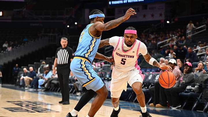 Feb 24, 2026; Washington, District of Columbia, USA; Georgetown Hoyas guard KJ Lewis (5) dribbles as Marquette Golden Eagles guard Chase Ross (2) defends during the first half at Capital One Arena. Mandatory Credit: Brad Mills-Imagn Images