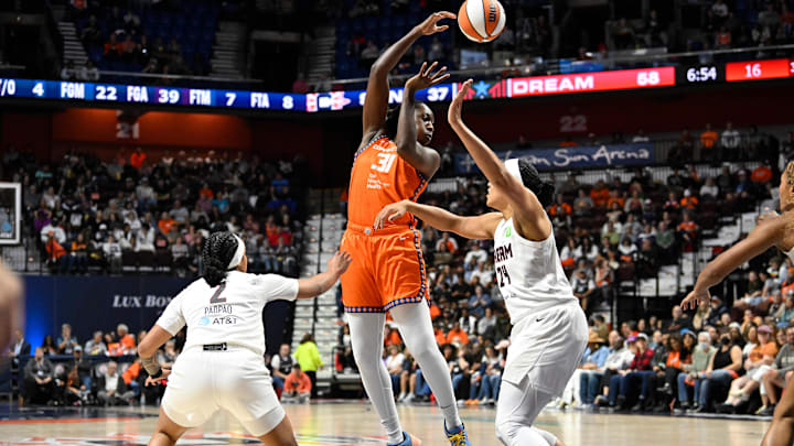 Sep 10, 2025; Uncasville, Connecticut, USA; Connecticut Sun center Tina Charles (31) passes the ball against Atlanta Dream forward Brionna Jones (24) and guard Te-Hina Paopao (2) during the second half at Mohegan Sun Arena.
