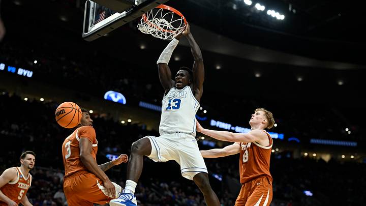 Mar 19, 2026; Portland, OR, USA; BYU Cougars center Keba Keita (13) dunks against Texas Longhorns forward Dailyn Swain (3) and center Matas Vokietaitis (8) in the second half during a first round game of the men's 2026 NCAA Tournament at Moda Center. Mandatory Credit: Troy Wayrynen-Imagn Images