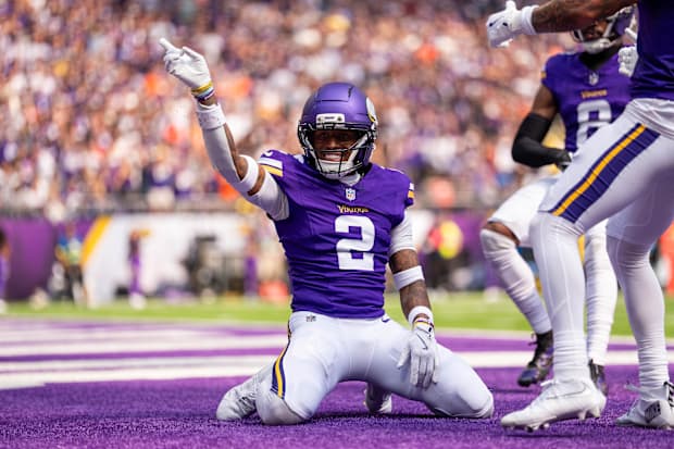 Isaiah Rodgers kneels and points in theend zone