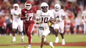 Oct 18, 2025; Fayetteville, Arkansas, USA; Texas A&M Aggies quarterback Mrcel Reed (10) rushes for a touchdown that was called back for holding during the fourth quarter against the Arkansas Razorbacks at Donald W. Reynolds Razorback Stadium. Mandatory Credit: Nelson Chenault-Imagn Images