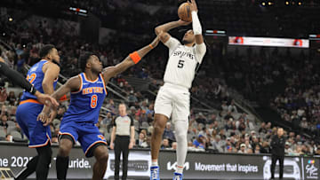 Mar 19, 2025; San Antonio, Texas, USA; San Antonio Spurs guard Stephon Castle (5) shoots over New York Knicks forward OG Anunoby (8) during the first half at Frost Bank Center. Mandatory Credit: Scott Wachter-Imagn Images