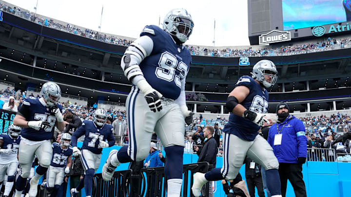 Dec 15, 2024; Charlotte, North Carolina, USA;  Dallas Cowboys including defensive tackle Linval Joseph (93) and offensive tackle Dakoda Shepley (65) run on to the field before the game at Bank of America Stadium.