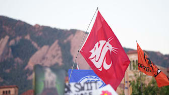 Sep 16, 2023; Boulder, Colorado, USA;  A fan holds a Washington State University flag on the set of ESPN College GameDay prior to the game between the Colorado Buffaloes and the Colorado State Rams at Folsom Field. Mandatory Credit: Andrew Wevers-Imagn Images