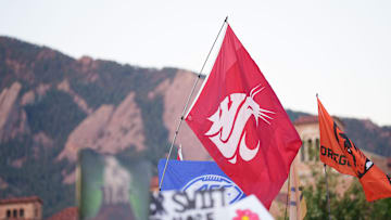 Sep 16, 2023; Boulder, Colorado, USA;  A fan holds a Washington State University flag on the set of ESPN College GameDay prior to the game between the Colorado Buffaloes and the Colorado State Rams at Folsom Field. Mandatory Credit: Andrew Wevers-Imagn Images
