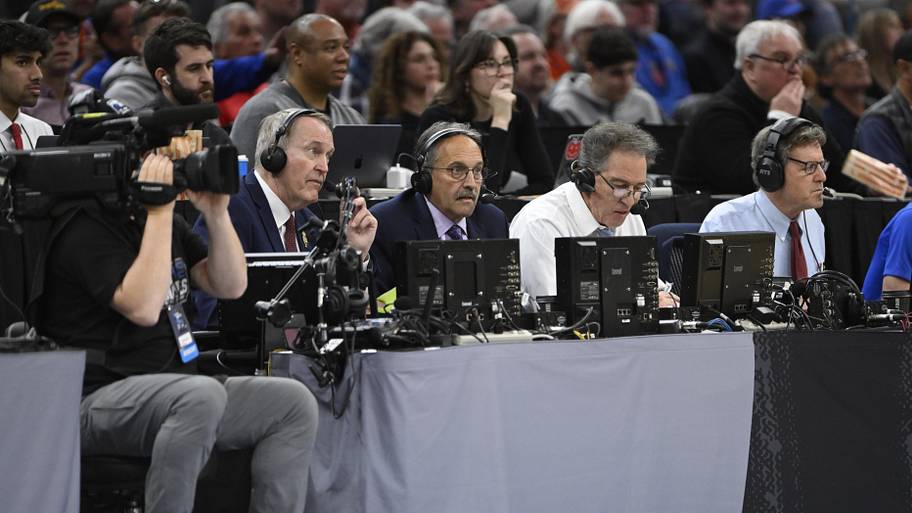 CBS Sports commentators Kevin Harlan, Stan Van Gundy and Dan Bonner sit near the court  during March Madness.