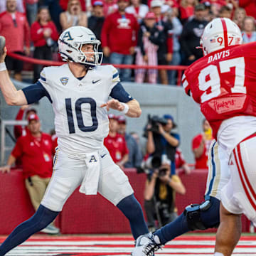 Nebraska defensive lineman Keona Davis pressures Akron quarterback Ben Finley.