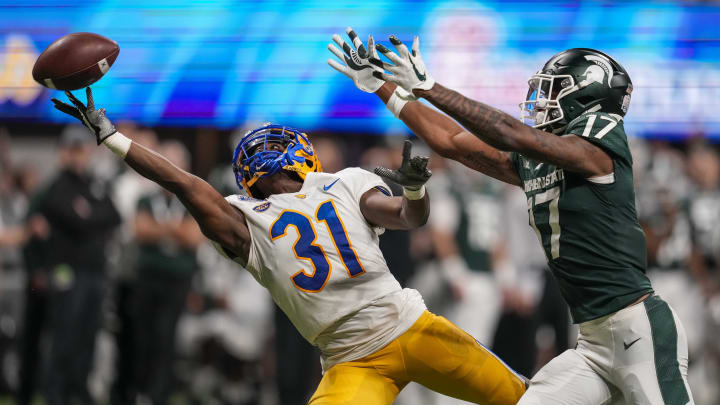 Dec 30, 2021; Atlanta, GA, USA; Pittsburgh Panthers defensive back Erick Hallett (31) reaches for a pass behind Michigan State Spartans wide receiver Tre Mosley (17) during the second half at Mercedes-Benz Stadium. Mandatory Credit: Dale Zanine-USA TODAY Sports