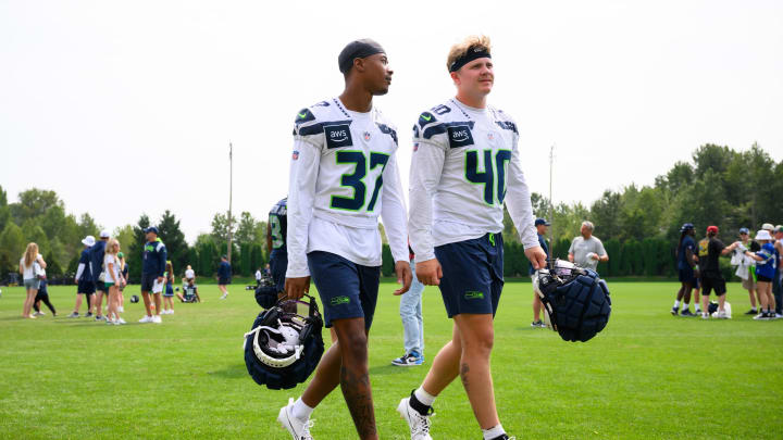 Jul 27, 2024; Renton, WA, USA; Seattle Seahawks cornerback Carlton Johnson (37) and linebacker Easton Gibbs (40) walk off the field after training camp at Virginia Mason Athletic Center. Mandatory Credit: Steven Bisig-USA TODAY Sports