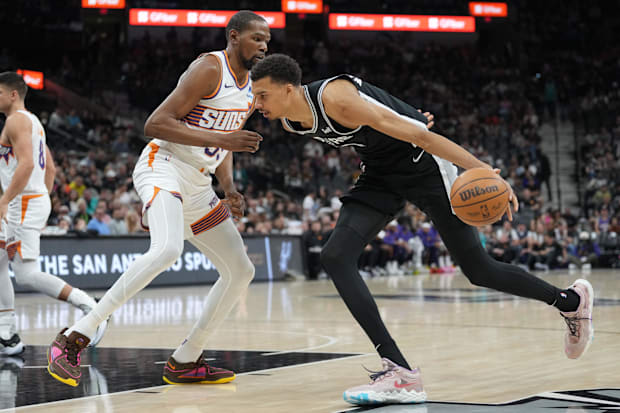 San Antonio Spurs center Victor Wembanyama (1) dribbles against Phoenix Suns forward Kevin Durant (35) in the first half at F