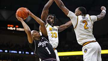 Feb 8, 2025; Columbia, Missouri, USA; Texas A&M Aggies guard Zhuric Phelps (1) shoots against Missouri Tigers center Josh Gray (33) and guard Tamar Bates (2) during the second half at Mizzou Arena. Mandatory Credit: Jay Biggerstaff-Imagn Images