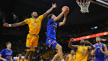 Dec 8, 2024; Columbia, Missouri, USA; Kansas Jayhawks guard Zeke Mayo (5) shoots the ball against Missouri Tigers guard Tamar Bates (2) and center Josh Gray (33) during the first half at Mizzou Arena. Mandatory Credit: Jay Biggerstaff-Imagn Images