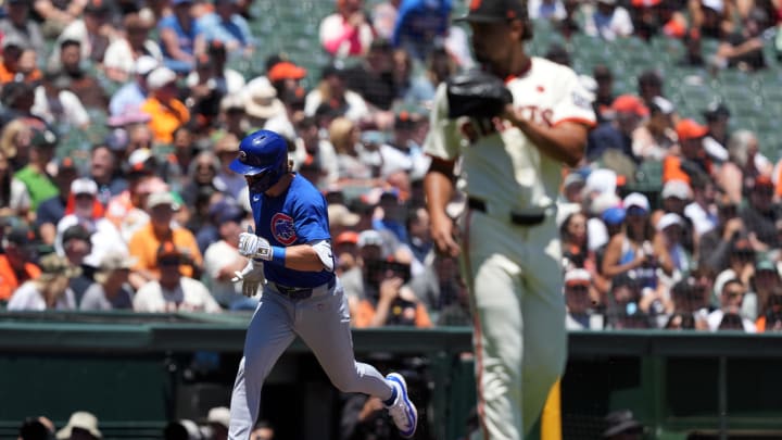 Jun 27, 2024; San Francisco, California, USA; Chicago Cubs second baseman Nico Hoerner (left) rounds the bases after hitting a home run against San Francisco Giants starting pitcher Jordan Hicks (right) during the third inning at Oracle Park. 