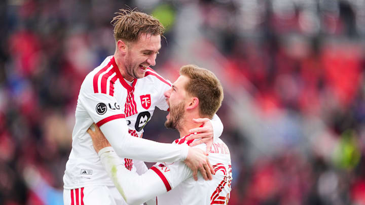 Walker Zimmerman and Djordje Mihailovic celebrate TFC's go-ahead goal - thanks to Zimmerman's header from a Mihailovic cross.