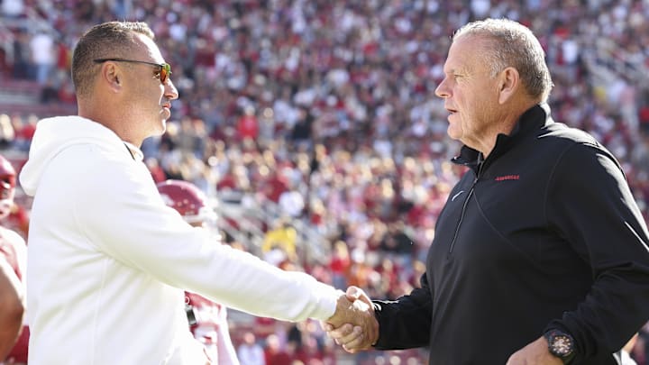Nov 16, 2024; Fayetteville, Arkansas, USA; Texas Longhorns head coach Steve Sarkisian and Arkansas Razorbacks head coach Sam Pittman interact prior to the game at Donald W. Reynolds Razorback Stadium. Mandatory Credit: Nelson Chenault-Imagn Images