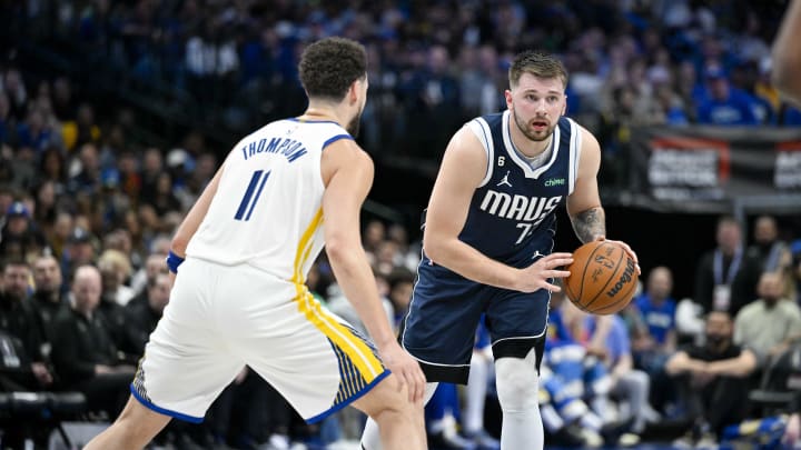 Mar 22, 2023; Dallas, Texas, USA; Golden State Warriors guard Klay Thompson (11) and Dallas Mavericks guard Luka Doncic (77) in action during the game between the Dallas Mavericks and the Golden State Warriors at the American Airlines Center. Mandatory Credit: Jerome Miron-USA TODAY Sports
