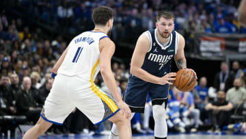 Mar 22, 2023; Dallas, Texas, USA; Golden State Warriors guard Klay Thompson (11) and Dallas Mavericks guard Luka Doncic (77) in action during the game between the Dallas Mavericks and the Golden State Warriors at the American Airlines Center. Mandatory Credit: Jerome Miron-USA TODAY Sports