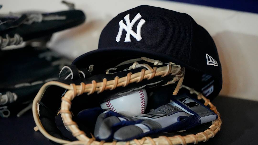 A look at a New York Yankees hat sitting on top of a baseball glove before a game against the Milwaukee Brewers.