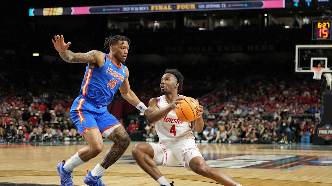 Apr 7, 2025; San Antonio, TX, USA; Houston Cougars guard L.J. Cryer (4) controls the ball against Florida Gators guard Alijah Martin (15) during the first half of the national championship game of the Final Four of the 2025 NCAA Tournament at the Alamodome. Mandatory Credit: Bob Donnan-Imagn Images