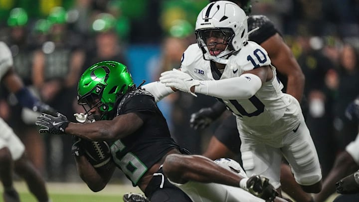 Oregon Ducks running back Noah Whittington (6) is brought down by Penn State Nittany Lions safety Dejuan Lane (10) on Saturday, Dec. 7, 2024, during the Big Ten Championship game at Lucas Oil Stadium in Indianapolis.