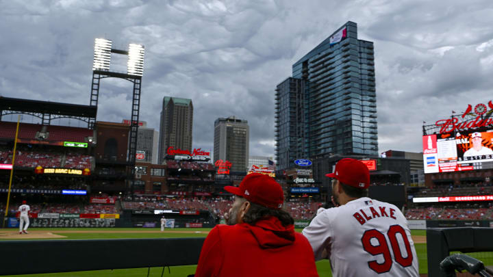 May 22, 2024; St. Louis, Missouri, USA;  St. Louis Cardinals starting pitcher Lance Lynn (31) and pitching coach Dusty Blake (90) watch as storm clouds move through the region during the fourth inning against the Baltimore Orioles at Busch Stadium. Mandatory Credit: Jeff Curry-USA TODAY Sports