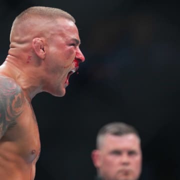 Jun 1, 2024; Newark, New Jersey, USA; Dustin Poirier (blue gloves) reacts during the fight against Islam Makhachev (red gloves) during UFC 302 at Prudential Center. Mandatory Credit: Joe Camporeale-USA TODAY Sports