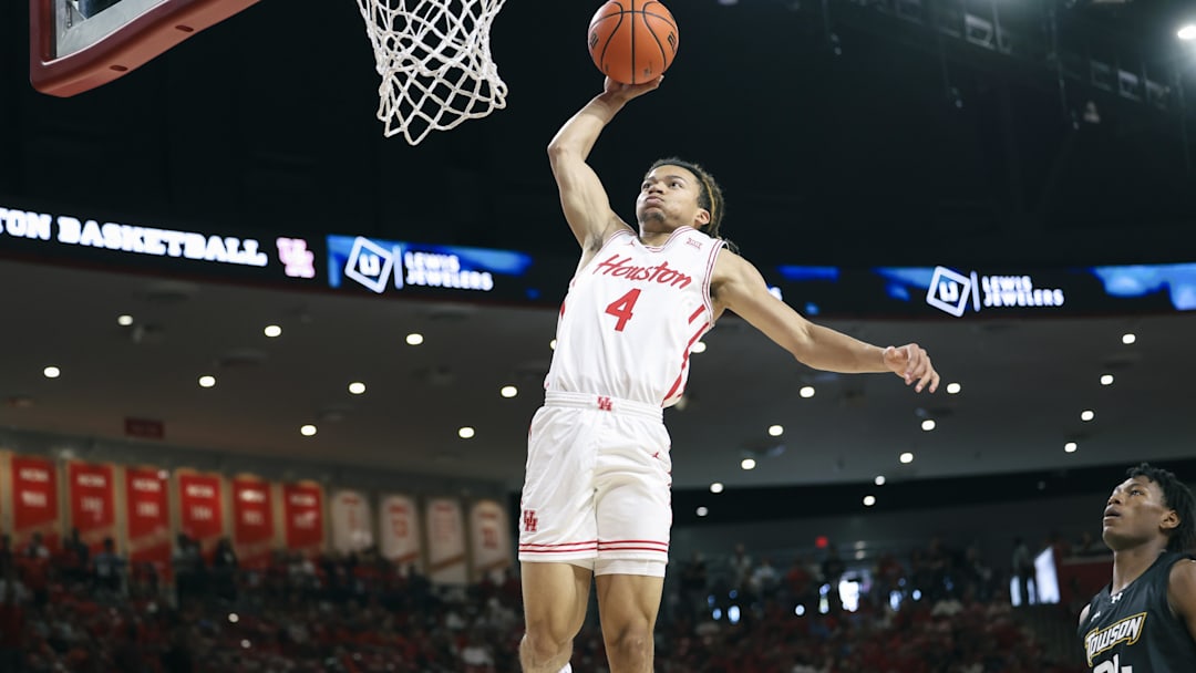 Nov 8, 2025; Houston, Texas, USA; Houston Cougars guard Kingston Flemings (4) dunks the ball during the first half against the Towson Tigers at Fertitta Center. Mandatory Credit: Troy Taormina-Imagn Images