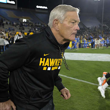 Nov 8, 2024; Pasadena, California, USA;  Iowa Hawkeyes head coach Kirk Ferentz leads his team on to the field for the game against the UCLA Bruins at the Rose Bowl. Mandatory Credit: Jayne Kamin-Oncea-Imagn Images