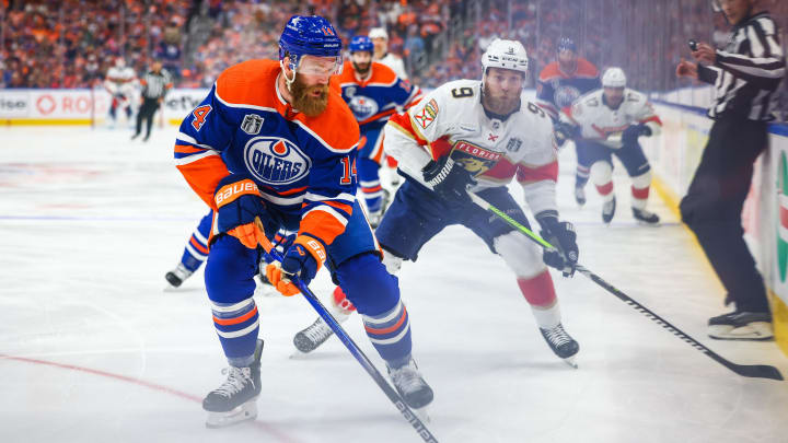 Jun 21, 2024; Edmonton, Alberta, CAN; Edmonton Oilers defenseman Mattias Ekholm (14) controls the puck against Florida Panthers center Sam Bennett (9) during the first period in game six of the 2024 Stanley Cup Final at Rogers Place. Mandatory Credit: Sergei Belski-USA TODAY Sports