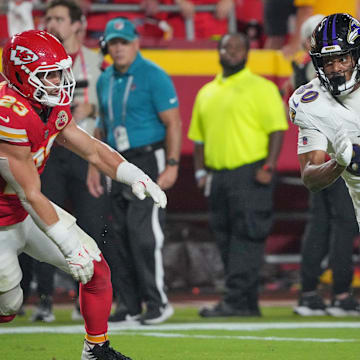 Sep 5, 2024; Kansas City, Missouri, USA; Baltimore Ravens tight end Isaiah Likely (80) runs the ball as Kansas City Chiefs linebacker Drue Tranquill (23) defends during the first half at GEHA Field at Arrowhead Stadium. Mandatory Credit: Denny Medley-Imagn Images