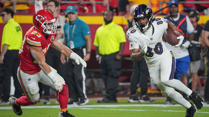 Sep 5, 2024; Kansas City, Missouri, USA; Baltimore Ravens tight end Isaiah Likely (80) runs the ball as Kansas City Chiefs linebacker Drue Tranquill (23) defends during the first half at GEHA Field at Arrowhead Stadium. Mandatory Credit: Denny Medley-Imagn Images