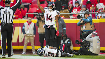 Dec 21, 2024; Kansas City, Missouri, USA; Houston Texans wide receiver Jared Wayne (14) calls for medical staff after an injury to wide receiver Tank Dell (3) during the second half against the Kansas City Chiefs at GEHA Field at Arrowhead Stadium. Mandatory Credit: Jay Biggerstaff-Imagn Images