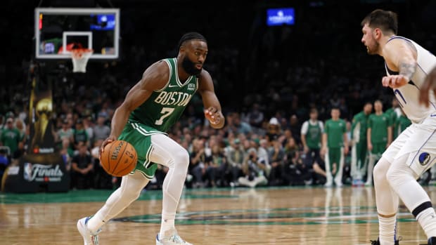 Jun 17, 2024; Boston, Massachusetts, USA; Boston Celtics guard Jaylen Brown (7) dribbles the ball against Dallas Mavericks guard Luka Doncic (77) during the fourth quarter in game five of the 2024 NBA Finals at TD Garden. Mandatory Credit: Peter Casey-USA TODAY Sports