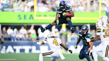 Seattle Seahawks running back Kenneth Walker III hurdles over New Orleans Saints cornerback Kool-Aid McKinstry