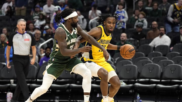 Apr 30, 2024; Milwaukee, Wisconsin, USA;  Indiana Pacers forward Aaron Nesmith (23) drives for the basket against Milwaukee Bucks guard Patrick Beverley (21) during the third quarter during game five of the first round for the 2024 NBA playoffs at Fiserv Forum. Mandatory Credit: Jeff Hanisch-USA TODAY Sports