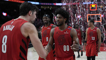 Dec 26, 2024; Portland, Oregon, USA; Portland Trail Blazers guard Scoot Henderson (00) celebrates with small forward Deni Avdija (8) after making the game-winning basket against the Utah Jazz at Moda Center. Mandatory Credit: Soobum Im-Imagn Images