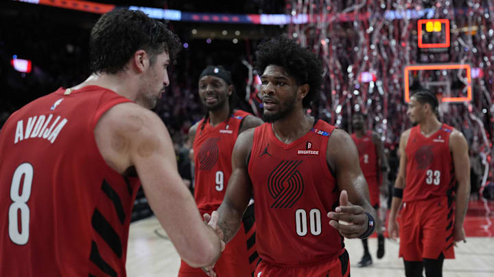 Dec 26, 2024; Portland, Oregon, USA; Portland Trail Blazers guard Scoot Henderson (00) celebrates with small forward Deni Avdija (8) after making the game-winning basket against the Utah Jazz at Moda Center. Mandatory Credit: Soobum Im-Imagn Images