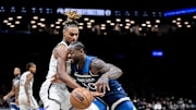 Nov 3, 2025; Brooklyn, New York, USA; Minnesota Timberwolves forward Julius Randle (30) tries to drive past Brooklyn Nets forward Noah Clowney (21) during the first half at Barclays Center. Mandatory Credit: John Jones-Imagn Images