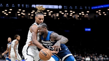 Nov 3, 2025; Brooklyn, New York, USA; Minnesota Timberwolves forward Julius Randle (30) tries to drive past Brooklyn Nets forward Noah Clowney (21) during the first half at Barclays Center. Mandatory Credit: John Jones-Imagn Images