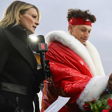 Kansas City Chiefs quarterback Patrick Mahomes and tight end Travis Kelce look at  football cakes while being interviewed by Netflix reporter Stacey Dales.