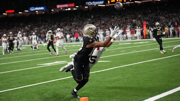 Oct 12, 2025; New Orleans, Louisiana, USA; New Orleans Saints wide receiver Chris Olave (12) misses a touchdown pass under pressure from New England Patriots cornerback Marcus Jones (25) during the second quarter at Caesars Superdome. Mandatory Credit: Matthew Hinton-Imagn Images
