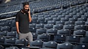 San Diego Padres general manager AJ Preller speaks on the phone during NLCS workouts at Petco Park on Oct. 17, 2022.