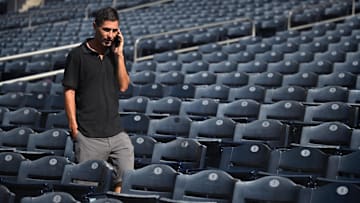 Oct 17, 2022; San Diego, CA, USA; San Diego Padres general manager AJ Preller speaks on the phone during NLCS workouts at Petco Park. Mandatory Credit: Orlando Ramirez-Imagn Images