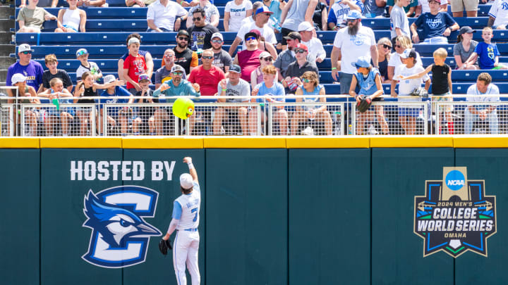 Jun 18, 2024; Omaha, NE, USA; North Carolina Tar Heels center fielder Vance Honeycutt (7) tosses a ball back into the stands during the fifth inning against the Florida State Seminoles at Charles Schwab Field Omaha.